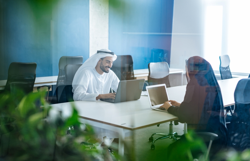 Man,And,Woman,With,Traditional,Clothes,Working,In,A,Business